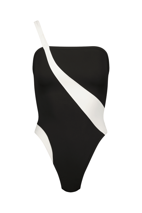 The Blake One Piece by Gigi C Bikinis is a sleek, modern swimsuit with a black colorblock design, single shoulder strap, and bold white diagonal stripe. It features durable scuba flatlock seaming for stylish beach excursions.