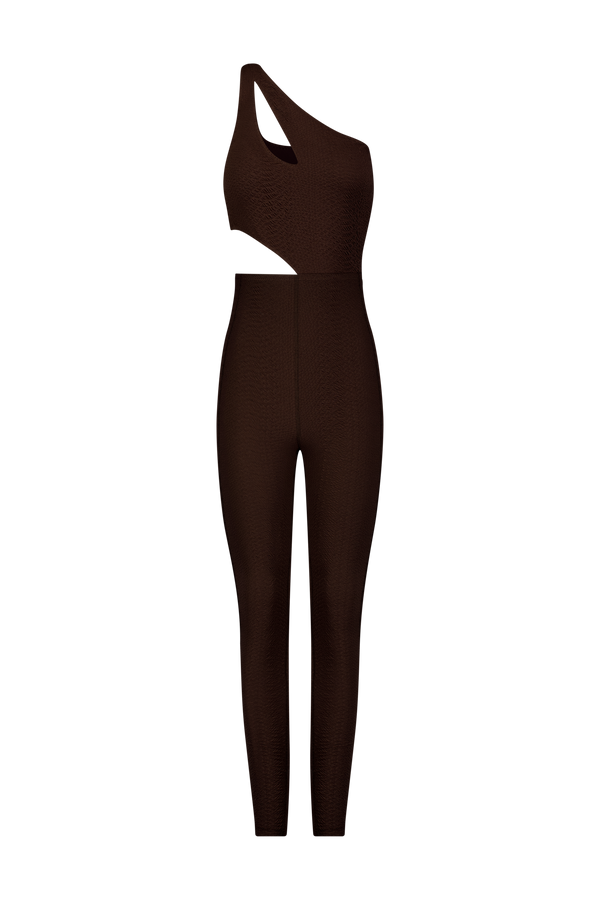The Rory Jumpsuit by Gigi C Sport is a sleek, brown one-shoulder asymmetrical design with a waist cutout. Made from bi-stretch compression fabric, it features a textured faux snake jacquard for a modern and stylish fit.
