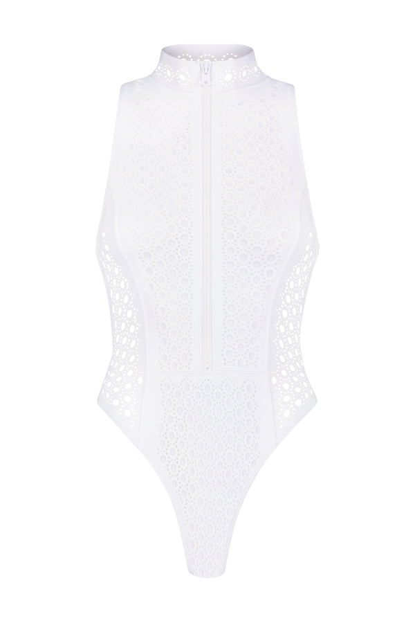The Brooks One Piece by Gigi C Bikinis is a white sleeveless bodysuit with a high neck and front zipper, crafted from luxury wax-coated scuba fabric. It features intricate cut-out details, blending elegance with modern style.