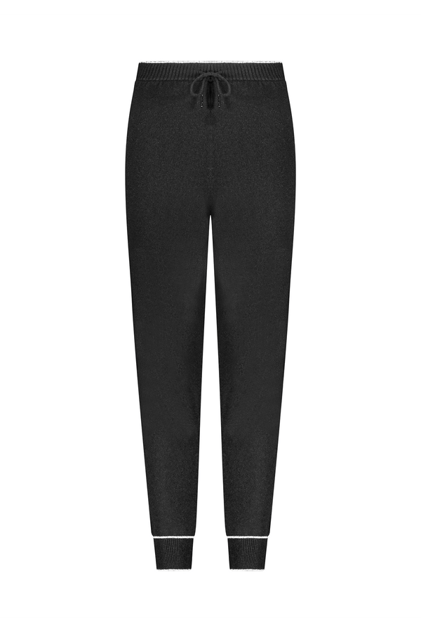 The Alice Jogger by Gigi C Lounge features black sweatpants with an elastic waistband, drawstring, and ankle-fitted cuffs. With a simple, casual design, these cozy loungewear pants offer style and comfort for everyday wear.
