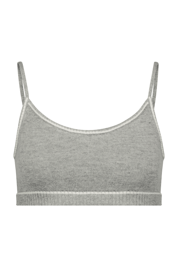 The front view of the Gray Danica Bralette from Gigi C Lounge features thin straps. Made from a luxurious wool cashmere blend, it offers a soft, stretchy feel with a simple design and ribbed hem. Set against a plain white background, it highlights its texture and color, epitomizing elegant luxury loungewear.