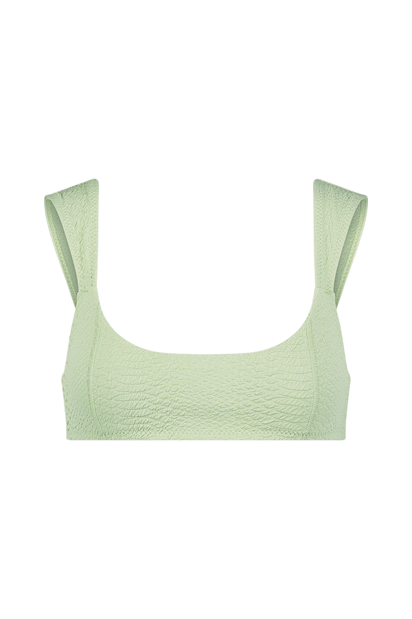 Meet the Dawson Top from Gigi C Bikinis: a light green textured cropped tank with wide straps, a scoop neckline, and removable bust pads. Displayed on black, it adds an edgy flair with its faux snake-inspired design.