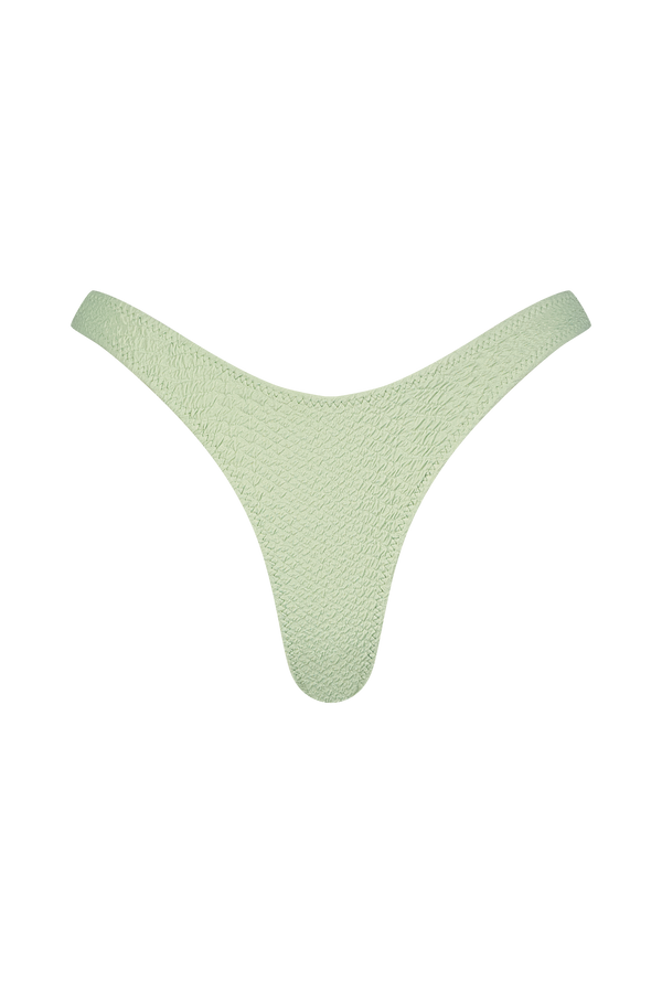 The Eva Bottom by Gigi C Bikinis is a light green, faux snake-textured thong on a black background, with high-cut legs tapering at the waist and offering cheeky bottom coverage.
