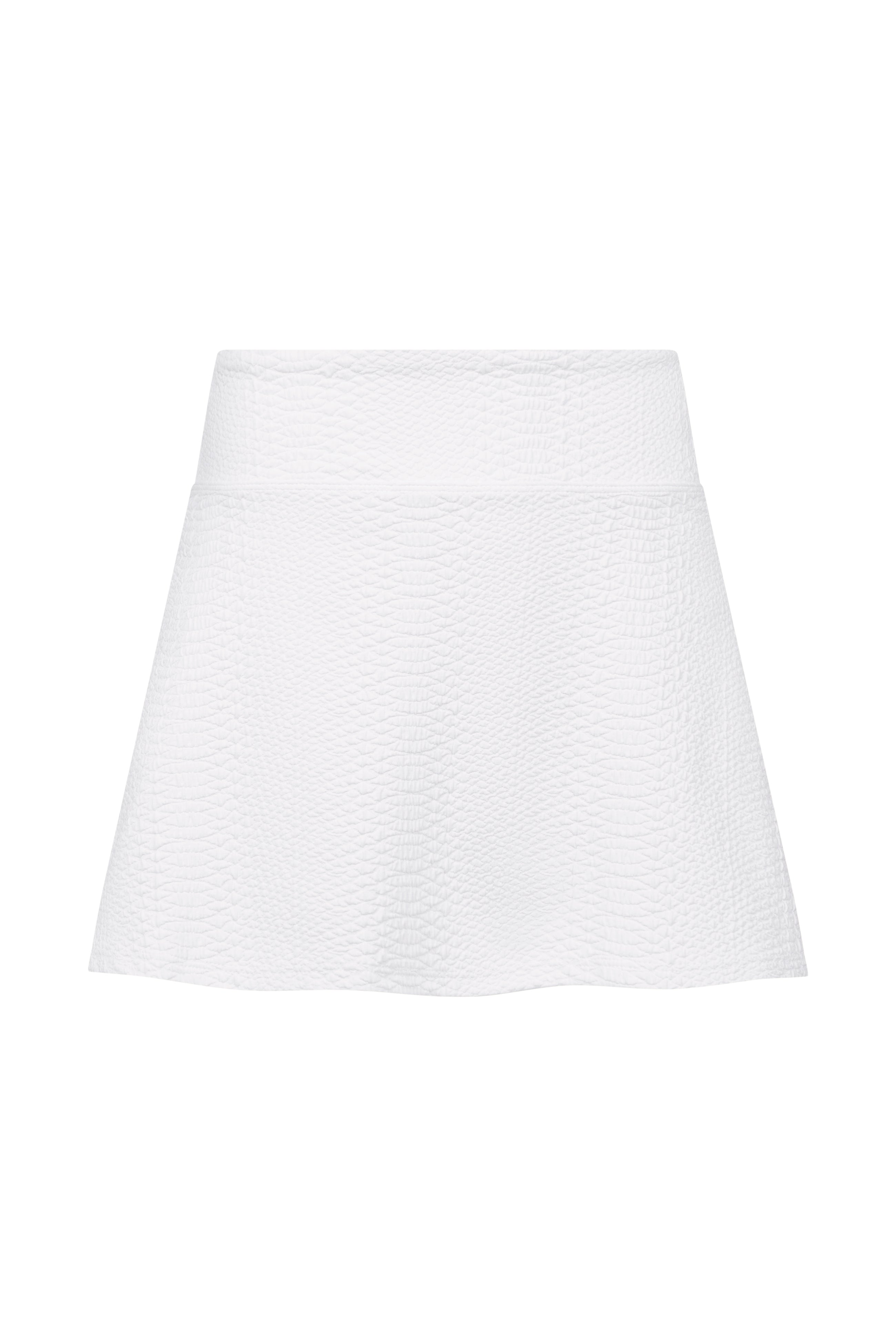 The Heidi Skort by Gigi C Sport is a high-waisted, white textured A-line skort crafted from bi-stretch compression fabric, displayed against a plain white background.