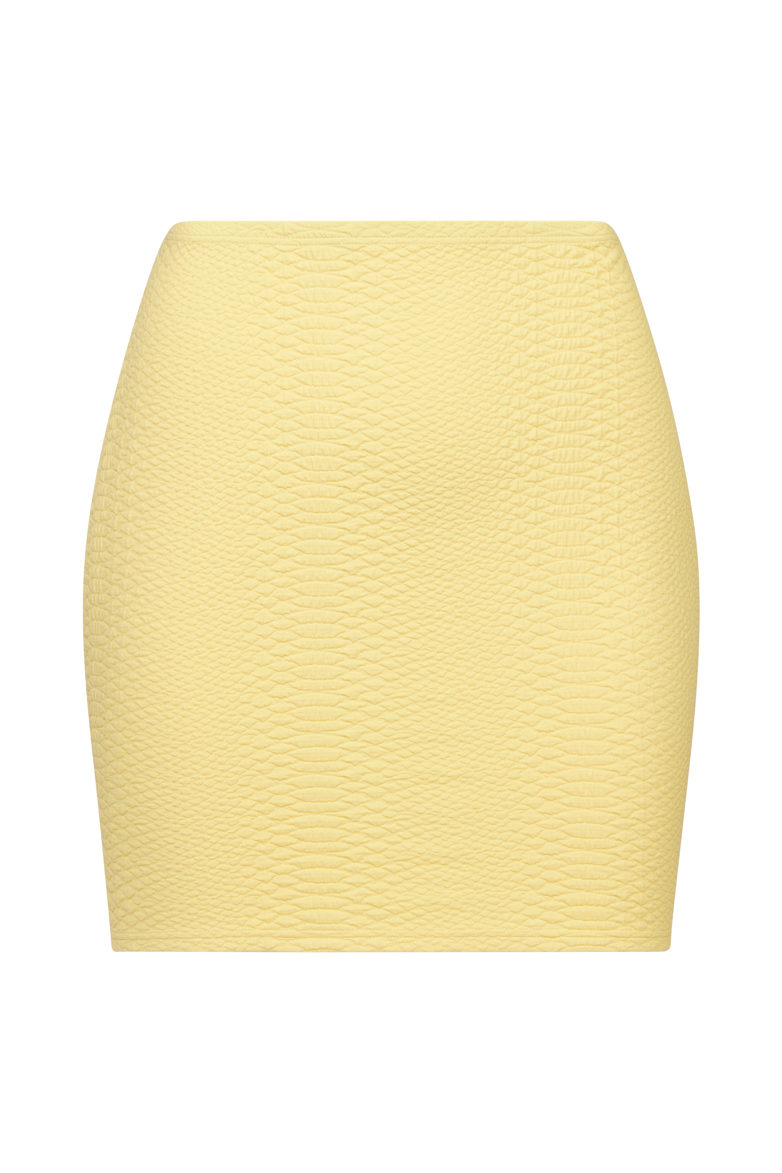 A close-up of the Gigi C Bikinis Joelle Skirt, a light yellow textured mini skirt with a wavy pattern. This form-fitting, high-waisted design features embossed fabric and a smooth finish, set against a white background.