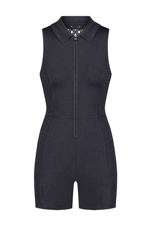 The Mina Romper by Gigi C Sport is a sleeveless black outfit with a front zipper, collared neckline, and side lace panels. This activewear piece elegantly combines simplicity and style, ideal for casual or semi-formal occasions.