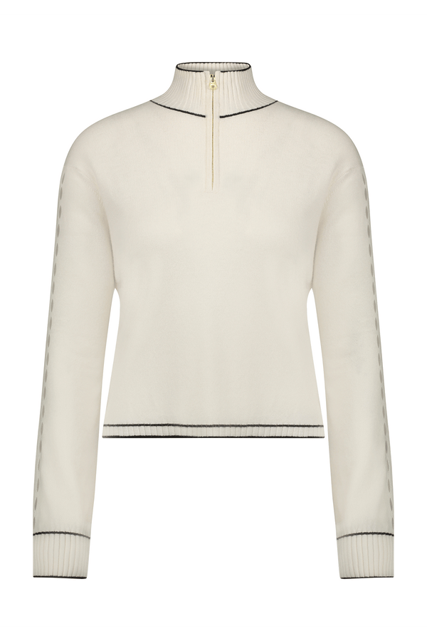 Introducing the June Sweater from Gigi C Lounge: a cream recycled cashmere pullover featuring long sleeves with black-trimmed cuffs, hem, and collar. The high neck showcases a GIGI C zipper slightly open at the top, complemented by subtle black side accents.
