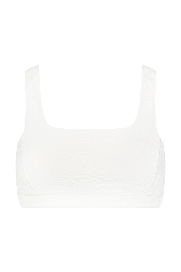 Front view of a Gigi C Sport Wilson Bra in plain white, showcasing wide straps and textured fabric with a square neckline against a solid black background.