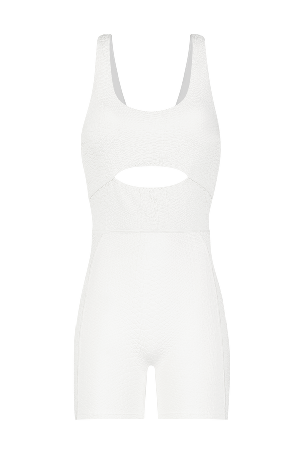 The Sawyer Romper by Gigi C Sport is a chic sleeveless white jumpsuit made from textured faux snake fabric, featuring a front cut-out below the bust, fitted design with shorts length, and an alluring open back.