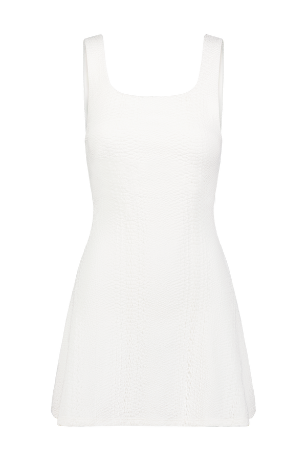 The Ezzie Dress by Gigi C Sport is a sleeveless white A-line outfit showcasing a textured design with tridimensional elasticity, highlighted by a chic square neckline against a solid black background.