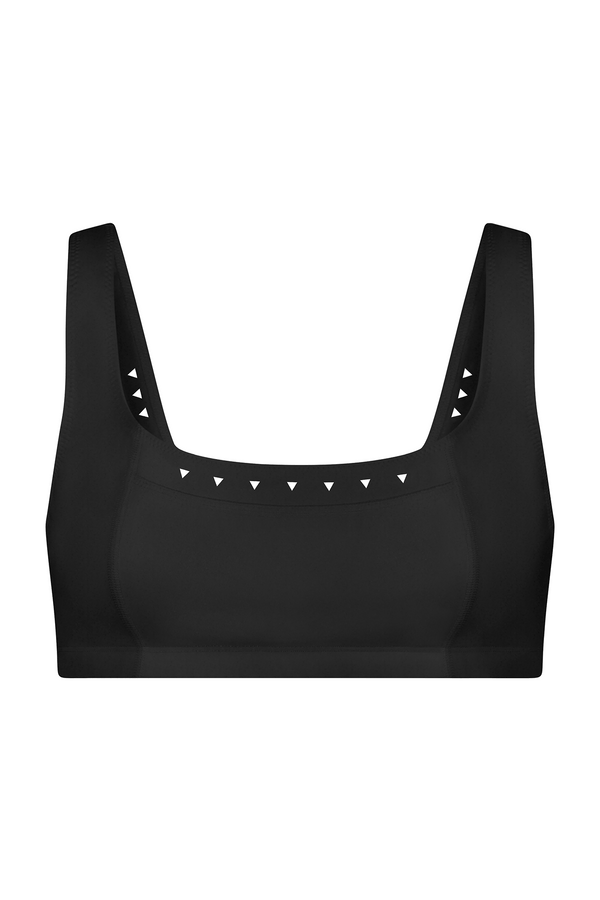The Emily Bra by Gigi C Sport is a black tennis bra made from breathable fabric, featuring wide straps and a square neckline. It includes small white triangles along the edge for subtle decoration.