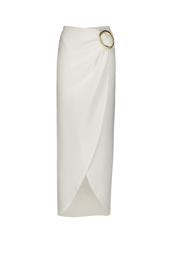 Introducing the Estelle Skirt by Gigi C Bikinis: a cream midi with a wrap design, thigh-high split, and large gold ring waist detail. Its luxurious fabric offers a textured pattern and elegant layered drape with a front overlap.