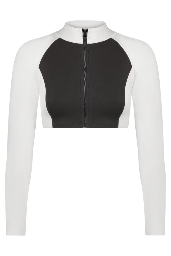 Discover the Missy Surf Jacket by Gigi C Bikinis: a cropped, long-sleeve sports top in silky scuba fabric, featuring a high neckline, black front, white sleeves, and a sleek center black zipper.