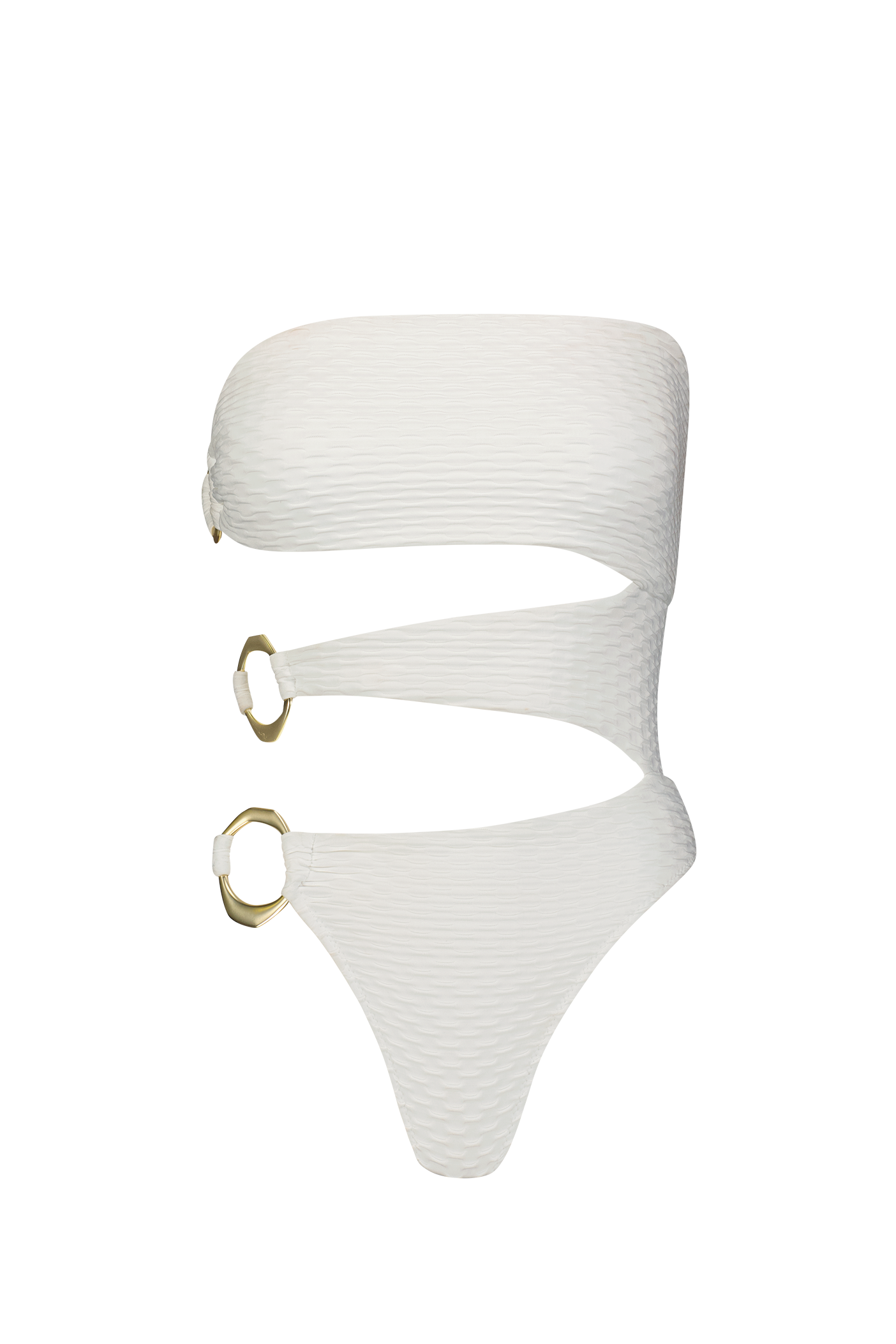 The Sami One Piece by Gigi C Bikinis is a white swimsuit with a ribbed texture and luxurious feel. It features a wraparound design with two large asymmetric brushed gold rings on the side, while its strapless top offers a bold, modern look against a black background.