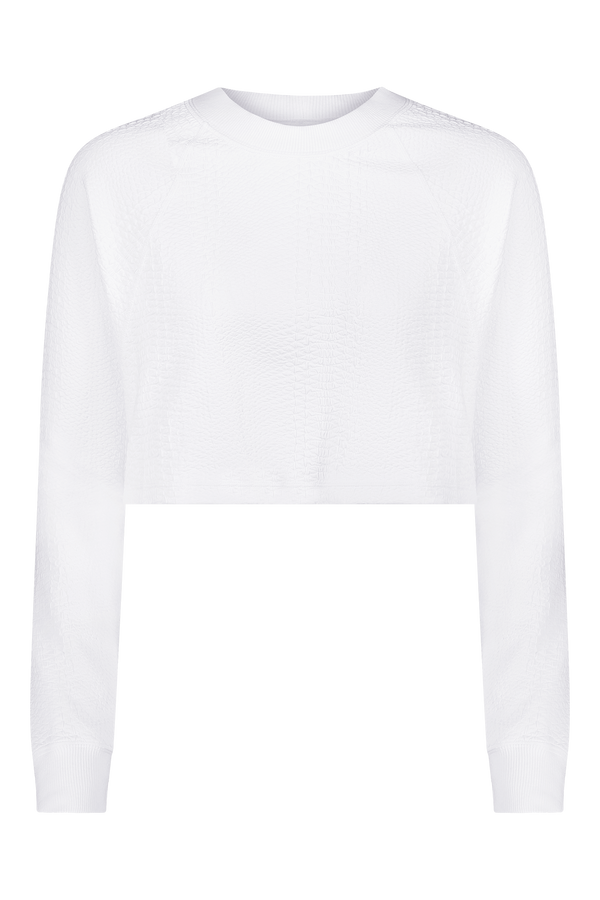 The Gigi C Sport Isabella Pullover is a plain white long-sleeve cropped sweater with ribbed crew neck and cuffs. Its smooth texture and subtle patterns add elegance to the design, while the transparent background highlights its clean lines.