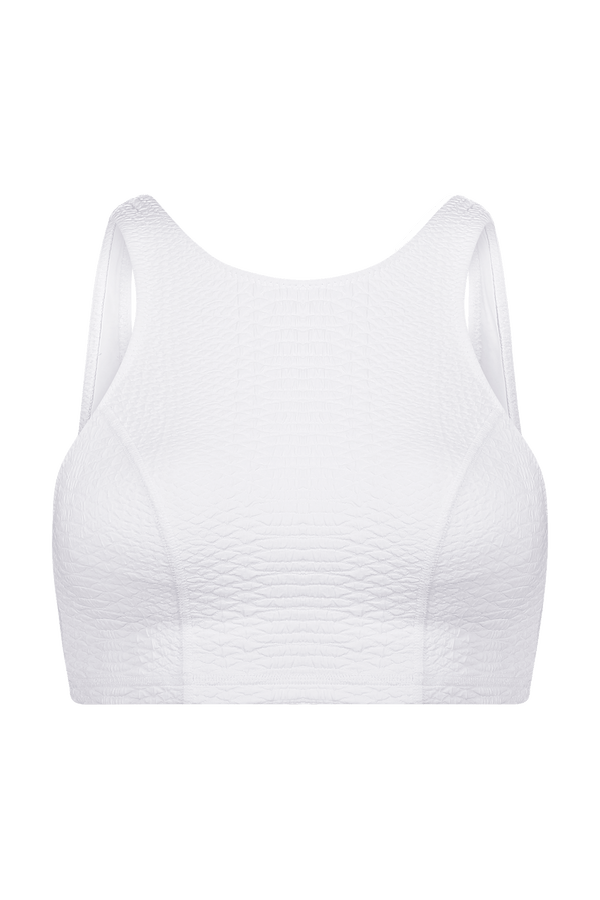 The Devon Top by Gigi C Sport is a white textured sports bra with medium support, featuring wide shoulder straps and a scoop neckline, displayed on a plain black background.