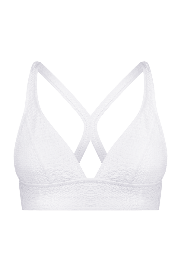 Front view of the Gigi C Sport Marissa Bra in white textured fabric, showcasing thin straps and a crisscross back for medium support. It exudes modern style with a faux snake detail hint.