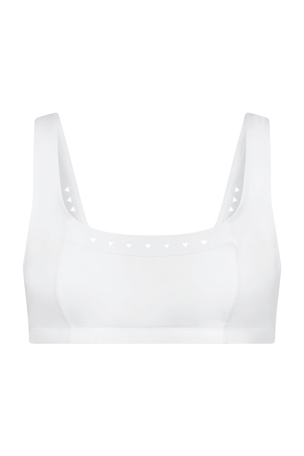 The Emily Bra by Gigi C Sport is a white, sleeveless tennis bra featuring a square neckline and triangle cut-out details along the inner straps. Made with breathable fabric and lasercut technology, it combines comfort and style in its simple, modern design.