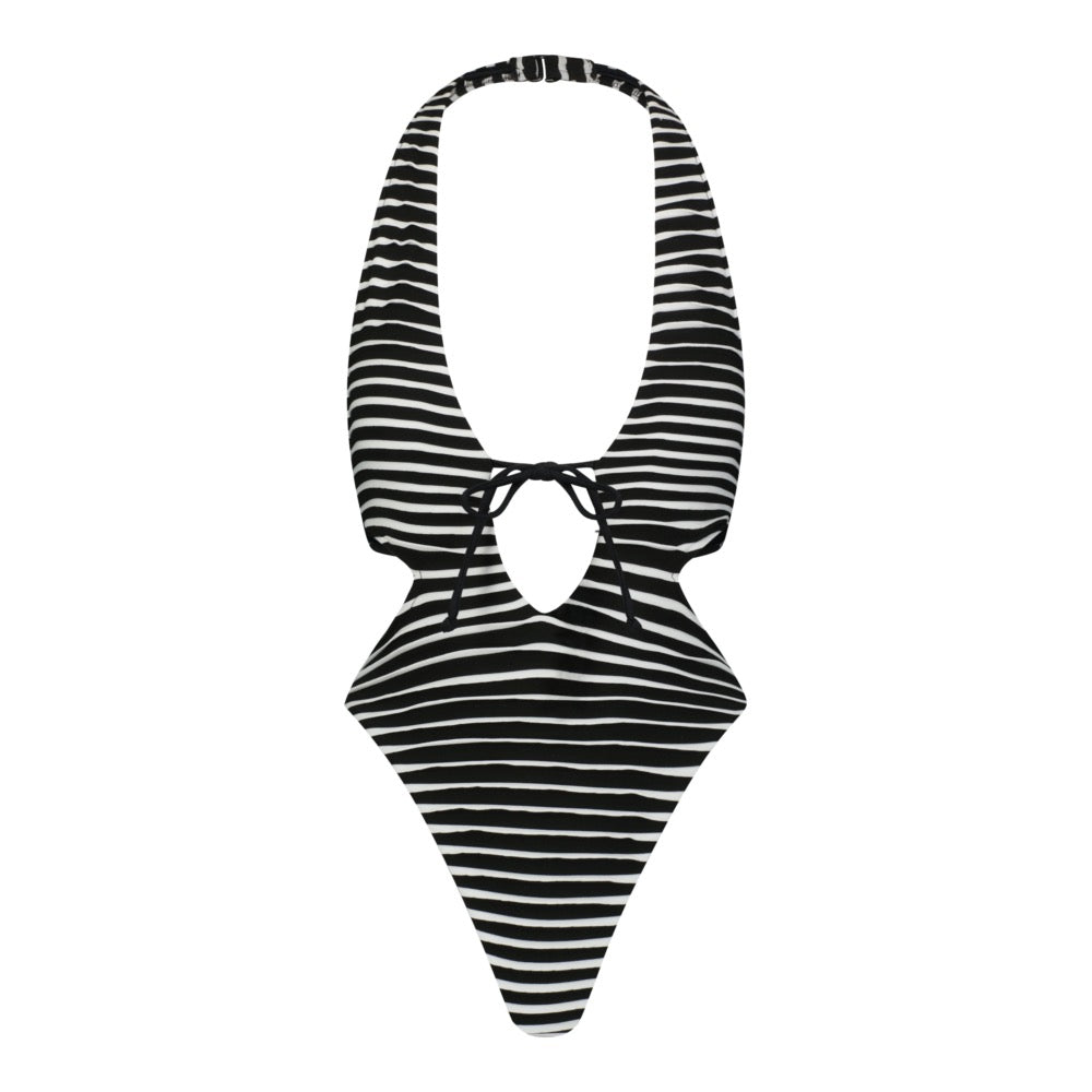 The Megan One Piece by Gigi C Bikinis features black and white stripes, a deep plunge neckline, a tie at the center, high-cut legs, and a circular opening below the bust. Crafted from textured black fabric for a chic look.