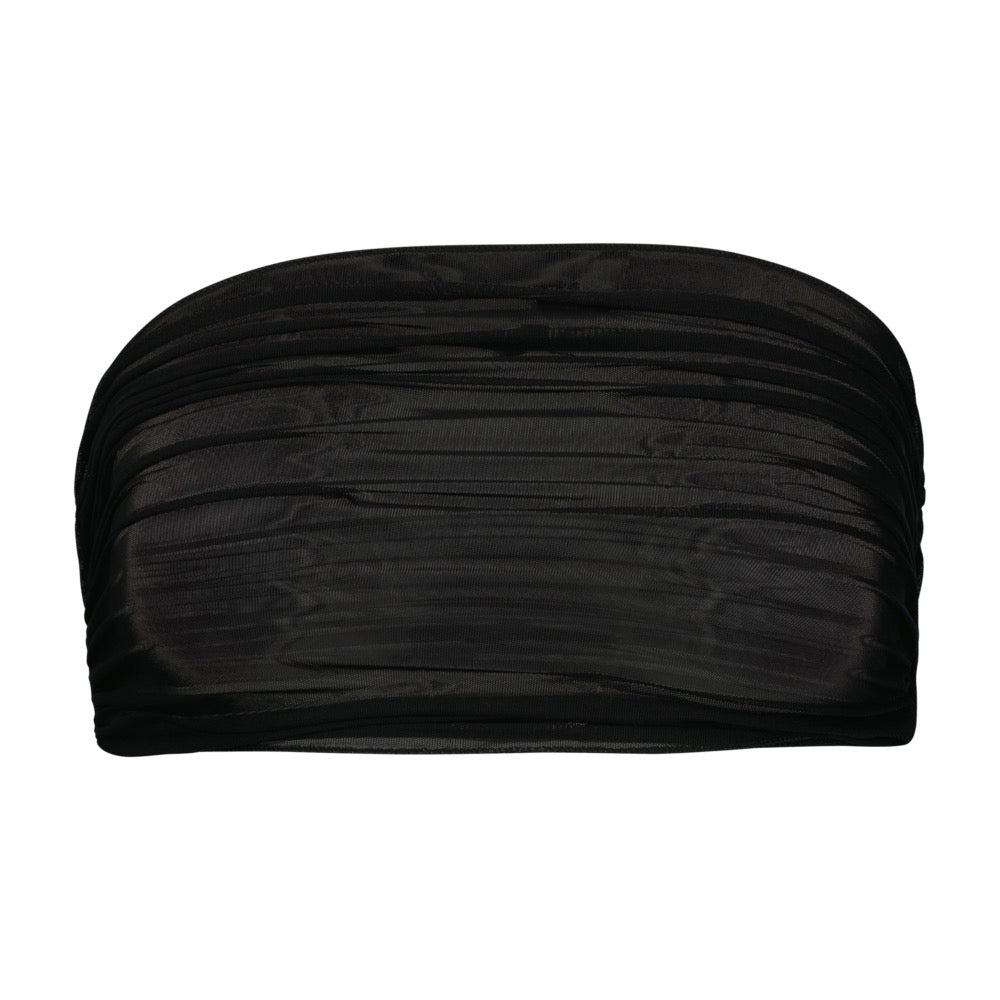 The Odette Top & Skirt by Gigi C Bikinis in black showcases a ruched fabric design with a fine mesh overlay, laid flat.