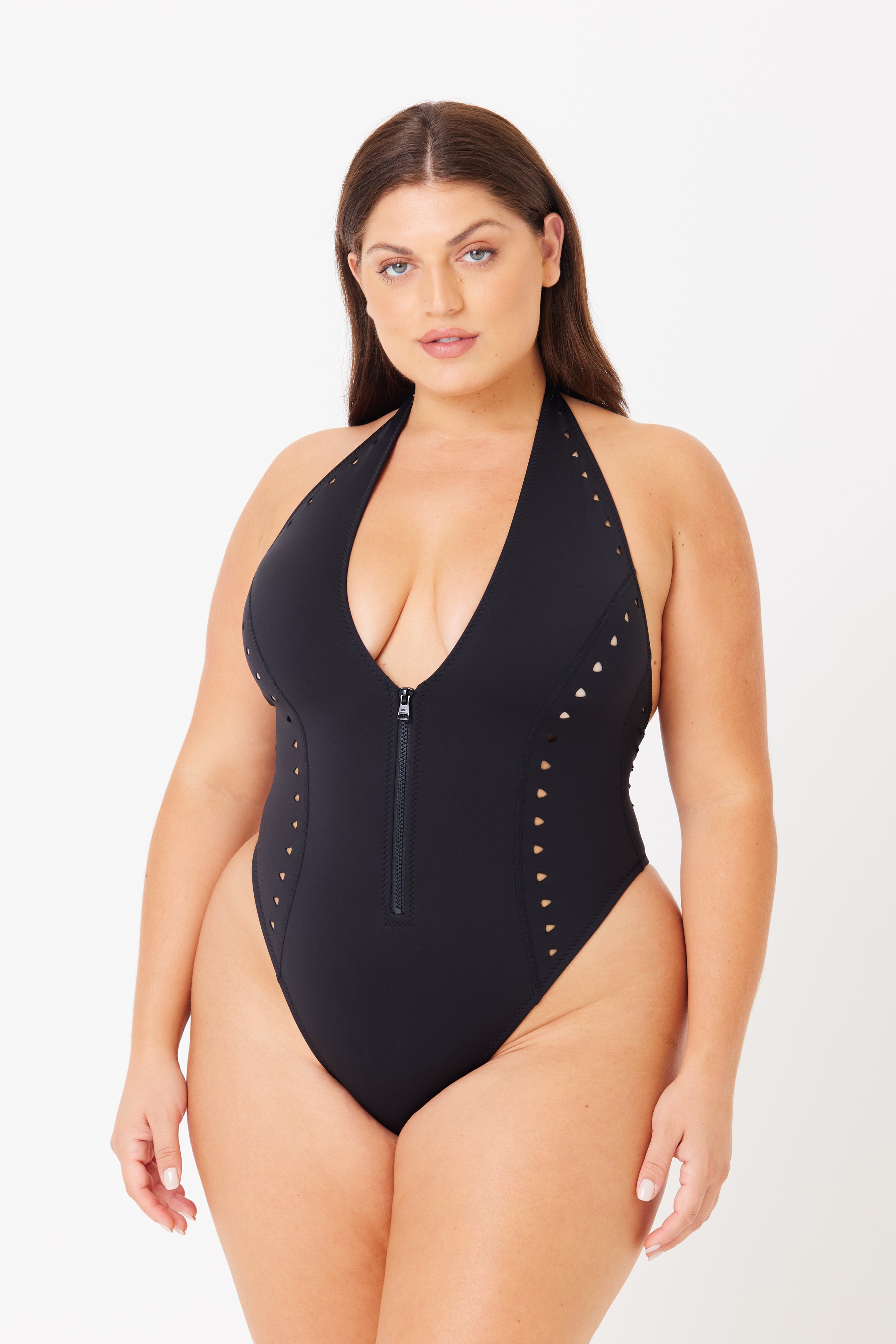 Someone is wearing the Grace One Piece by Gigi C Bikinis, a black swimsuit with triangle laser cutouts on the sides, a chic halter neck, and a scuba zipper front. The background is plain white.